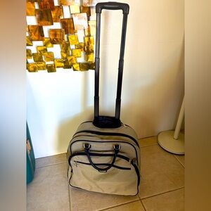 Baggallini Carry -On rolling bag with wheels and tall handle 20” by 18” by 12”